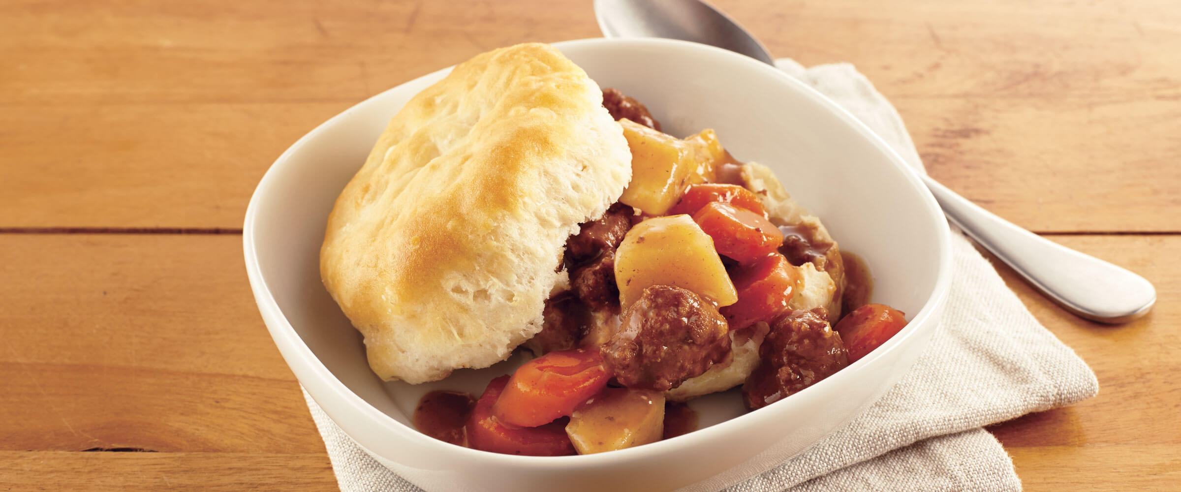 Beef Stew over Biscuits in white bowl