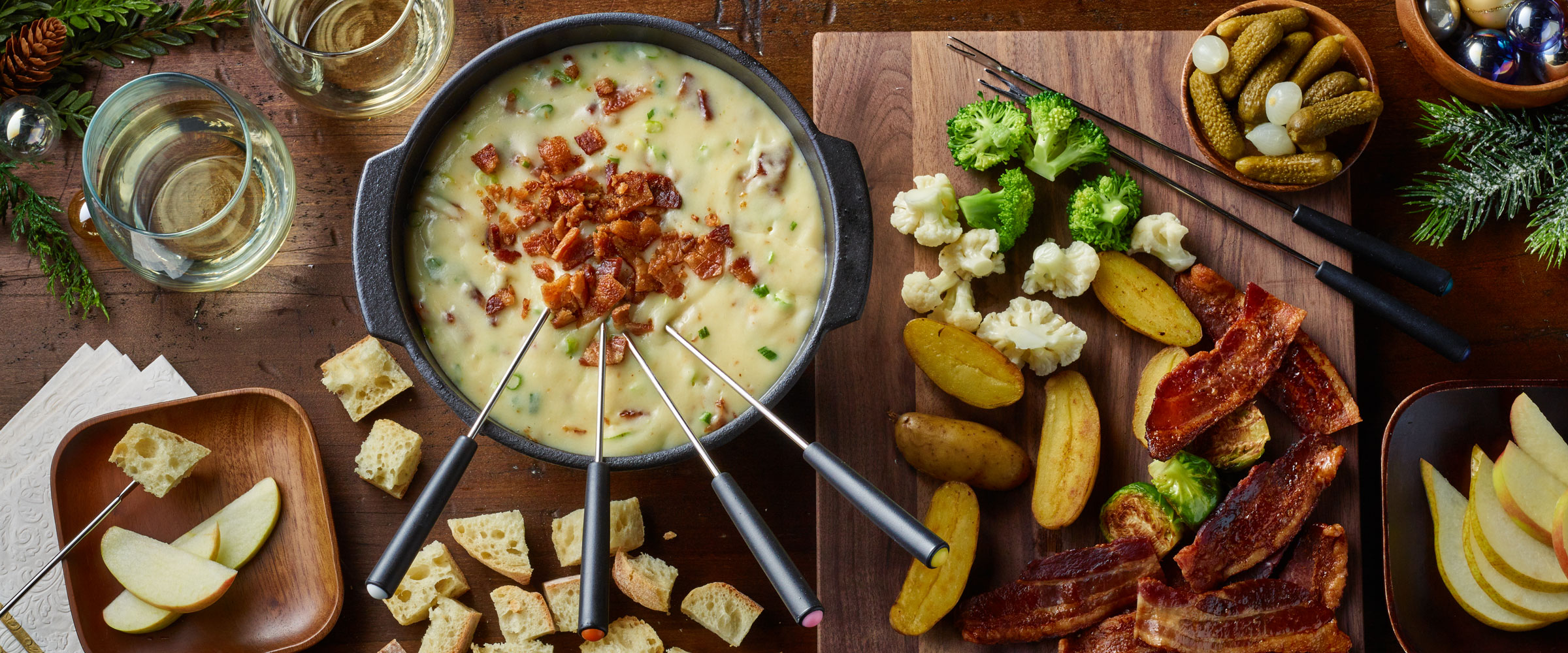 Bacon Fondue and accompaniments like crackers, vegetables and slices of bacon