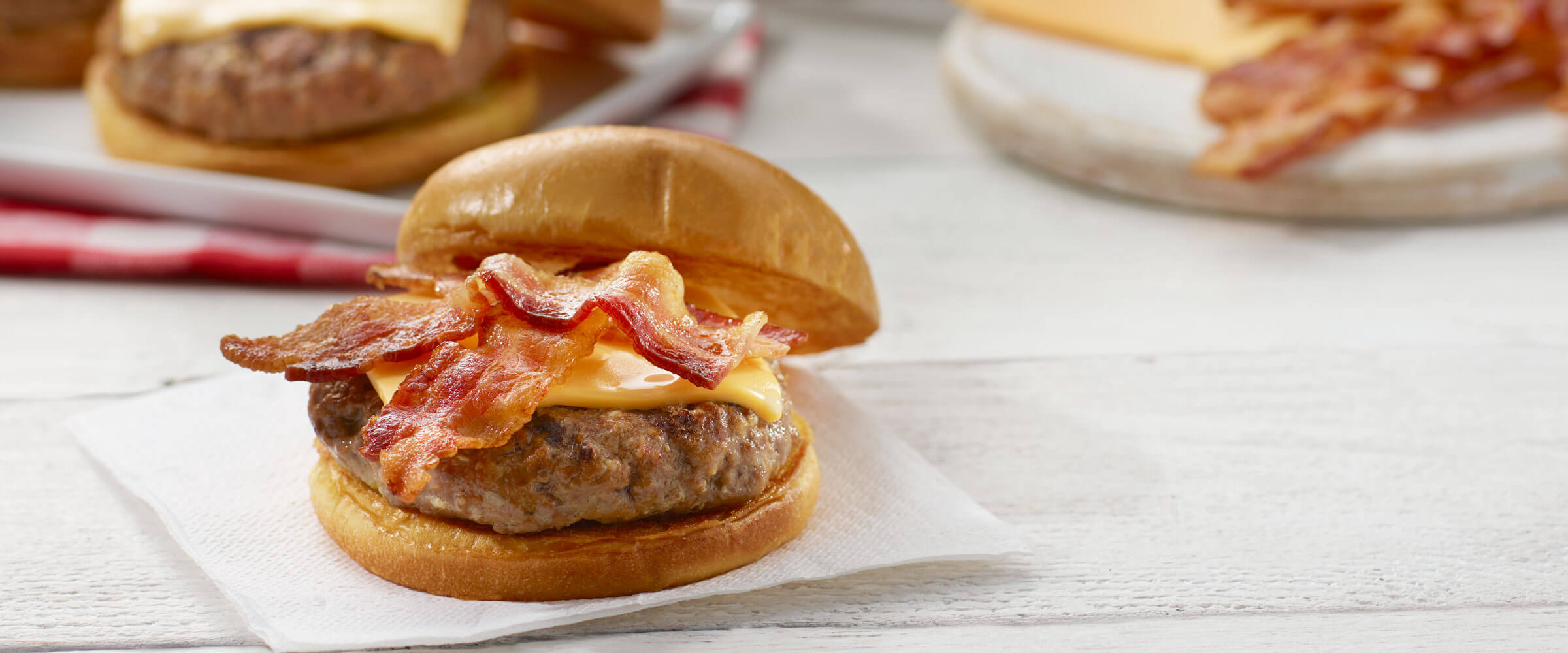 All-American Bacon Cheeseburgers on white napkin