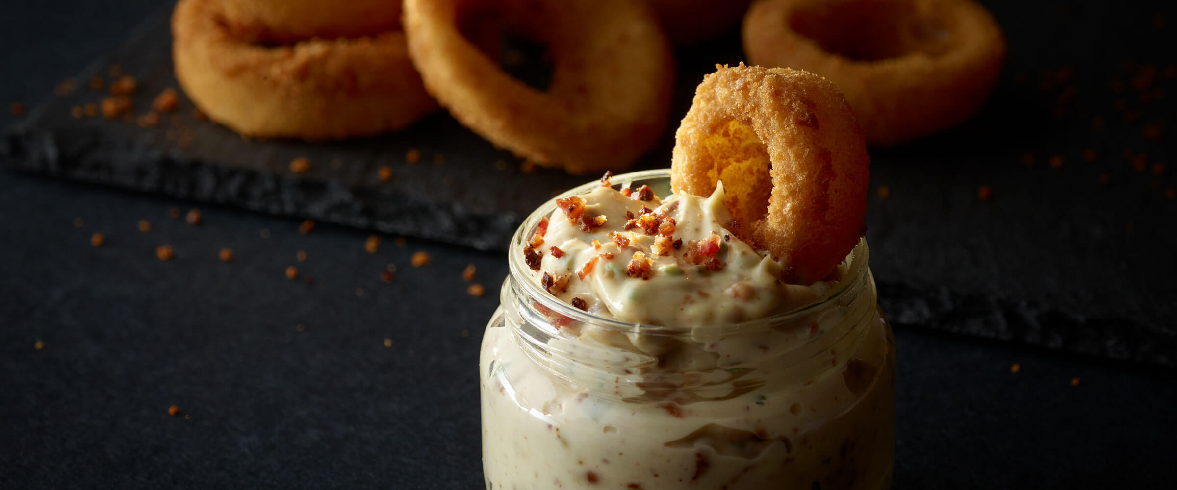 bacon mayo in glass jar with onion rings for dipping