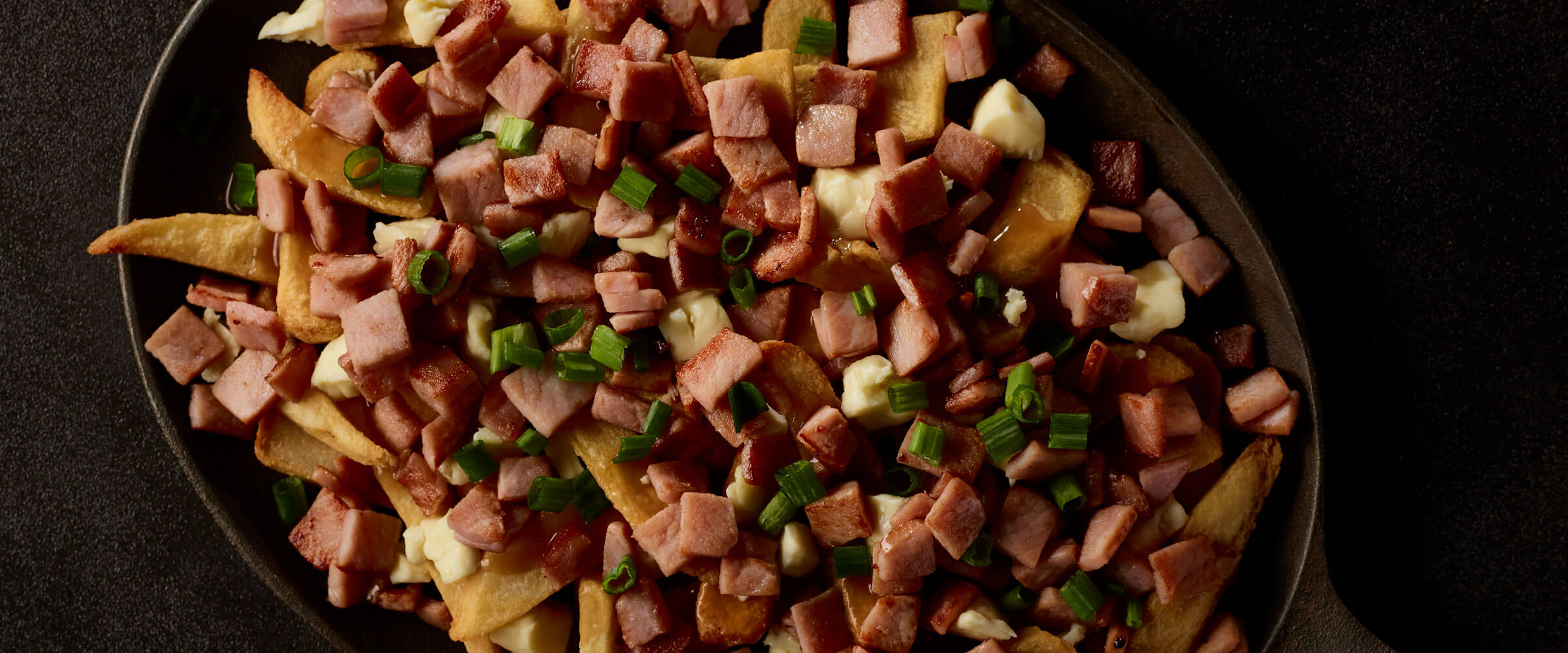 Canadian Bacon Poutine in serving dish