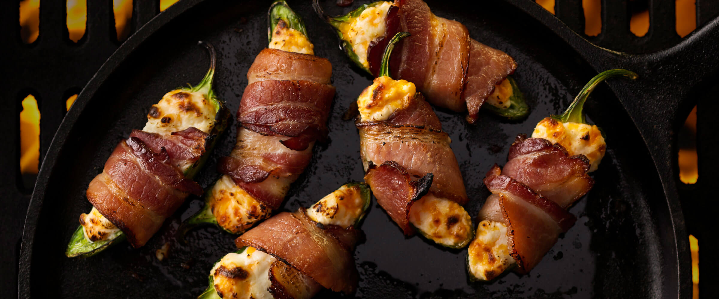 Pecanwood Bacon Wrapped Jalapeno Poppers in cast iron skillet