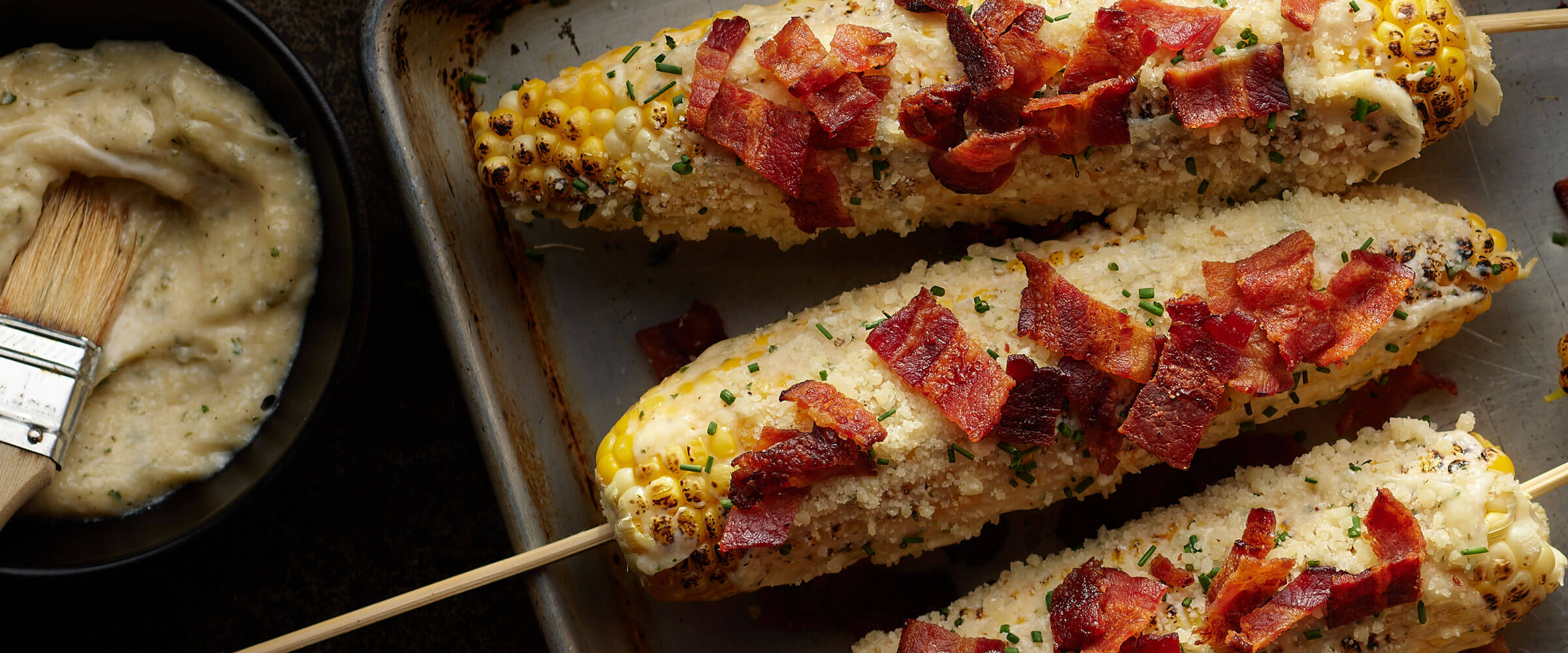 Bacon Mexican Street Corn on skewers on sheetpan