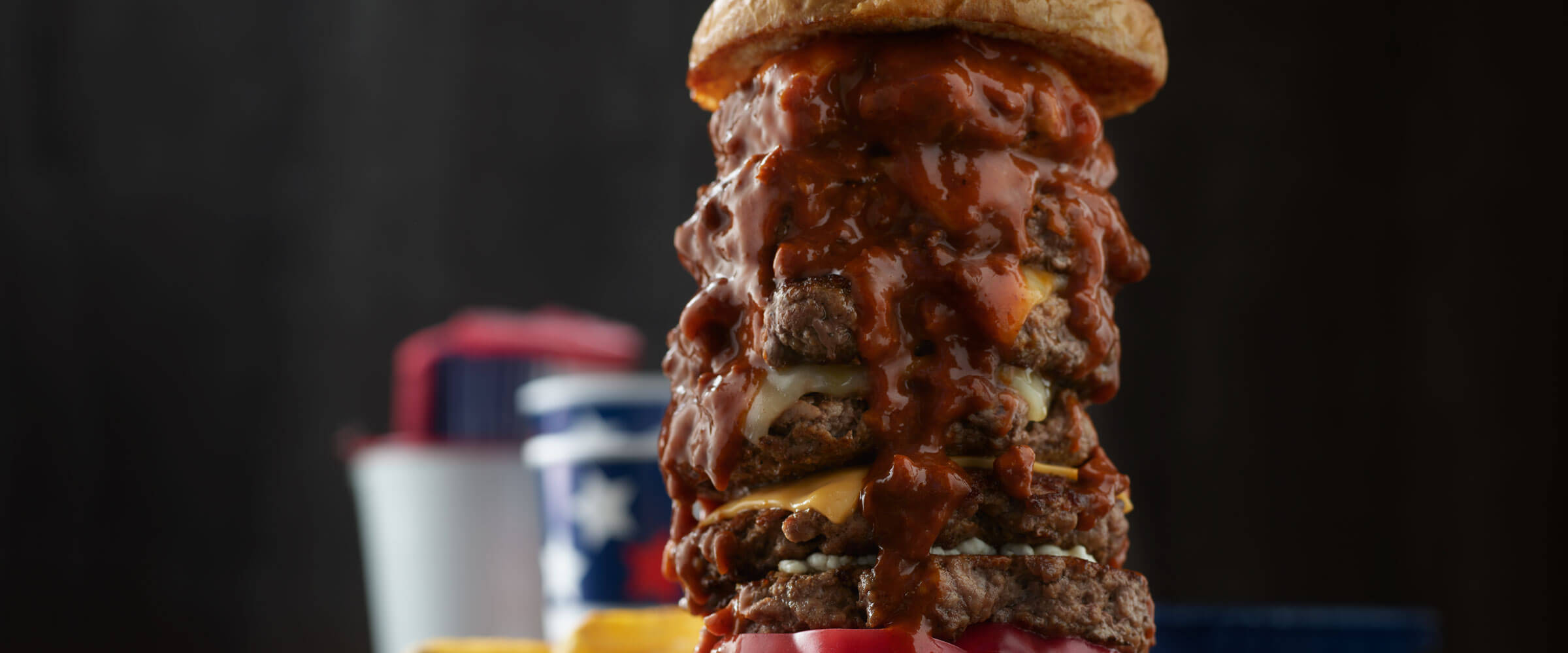 Chili Cheese Burger stacked six patties high with sauce