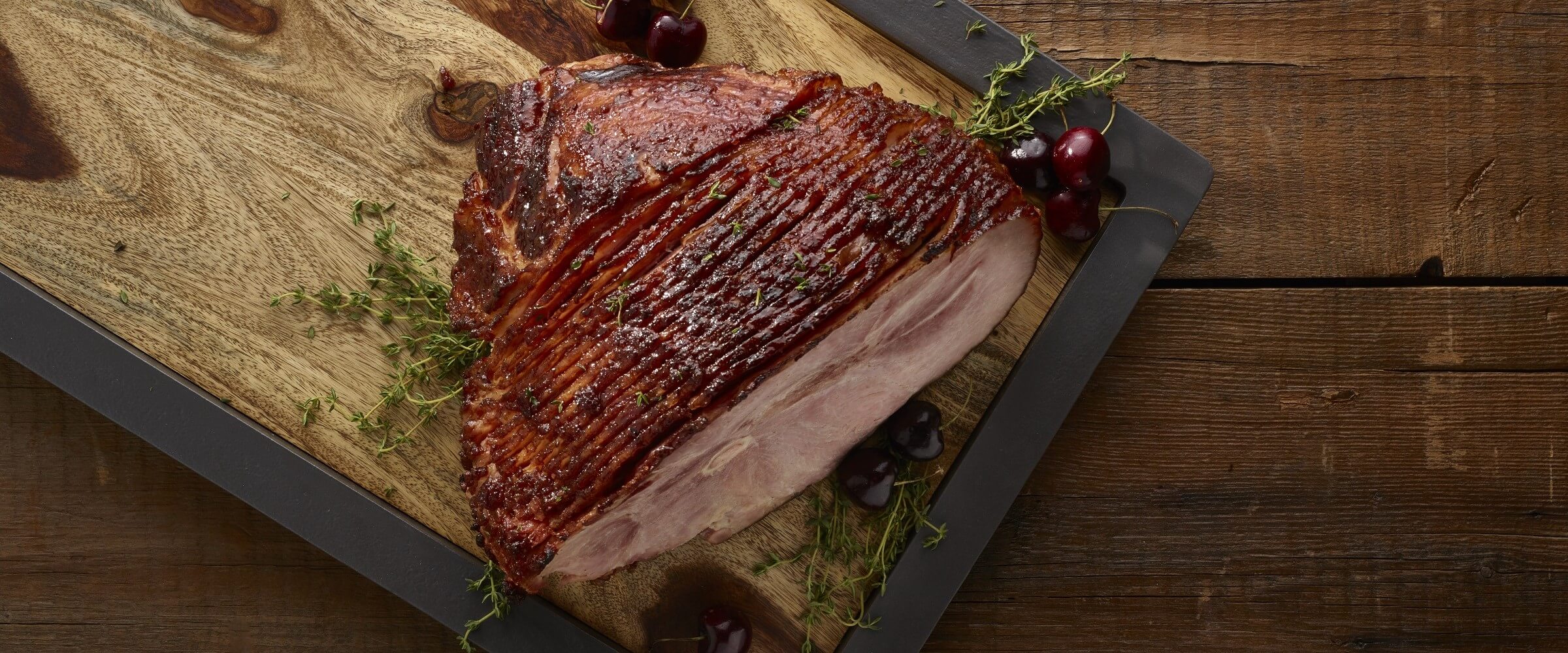 Cure 81 brown sugar cherry glaze ham on wood cutting board