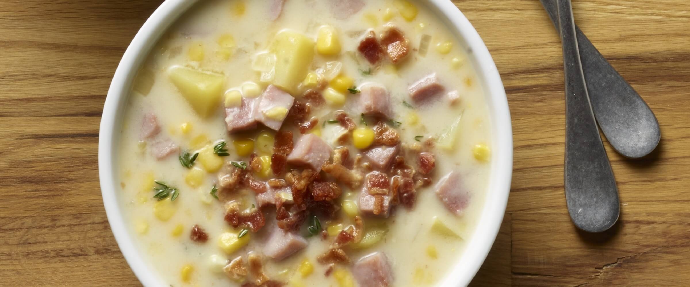 Cure 81 ham potato corn chowder in white bowl
