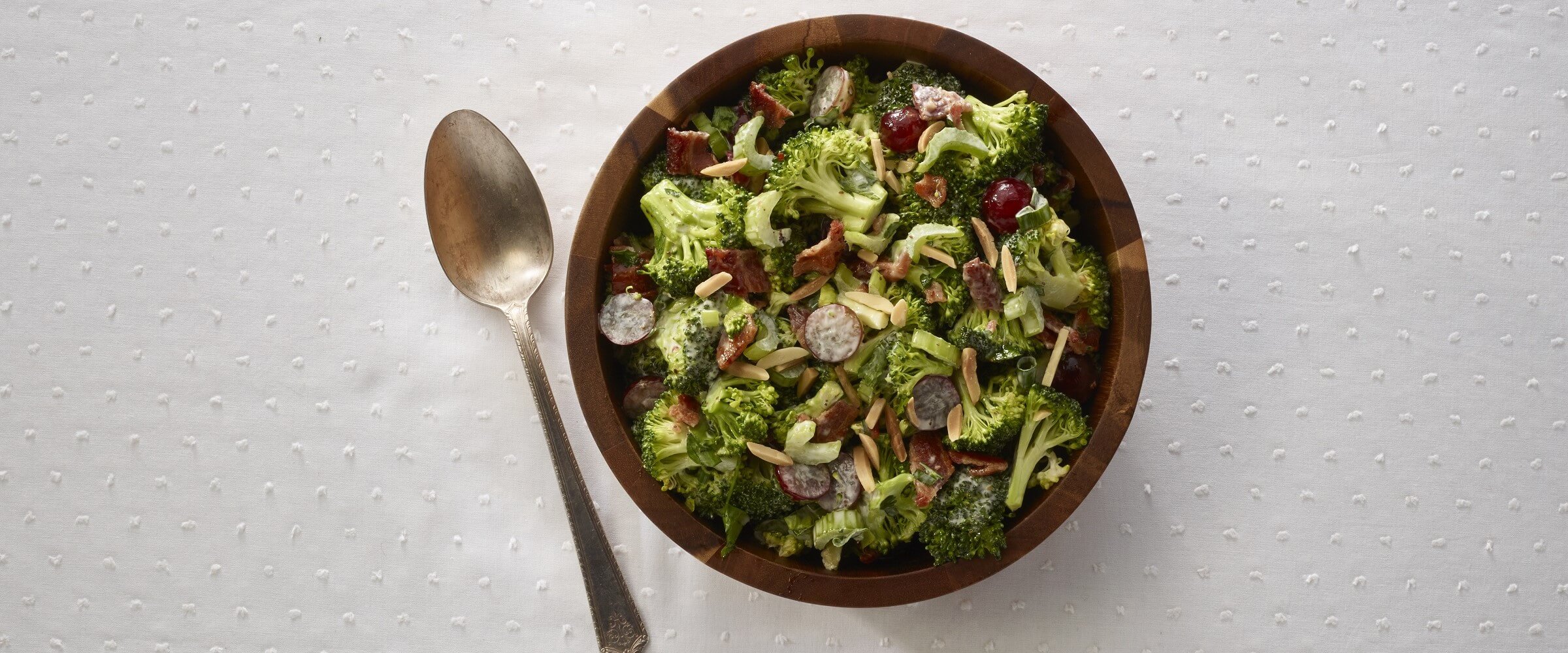bacon broccoli salad in wood bowl with spoon