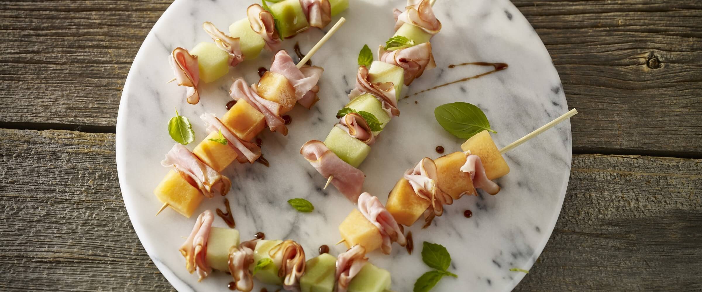 ham and melon skewers on circle platter