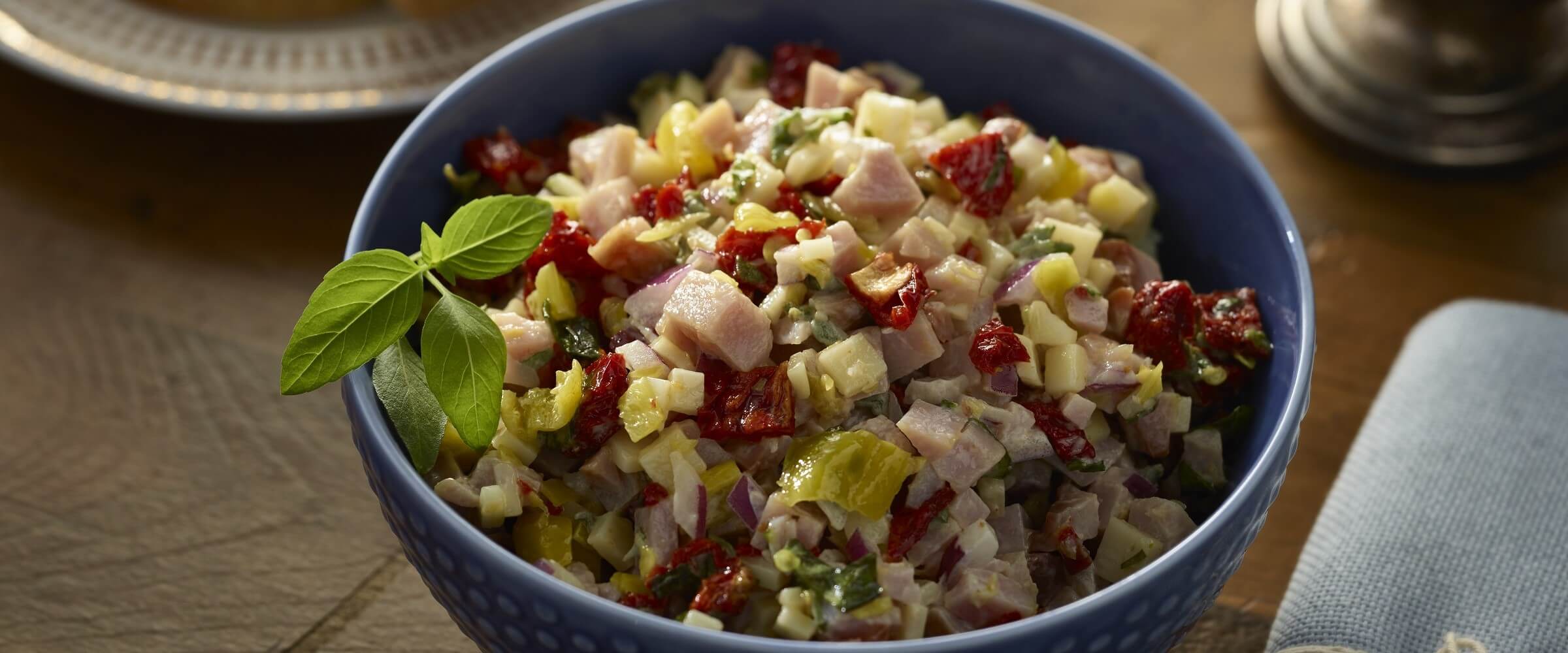 ham hoagie dip in blue bowl with garnish