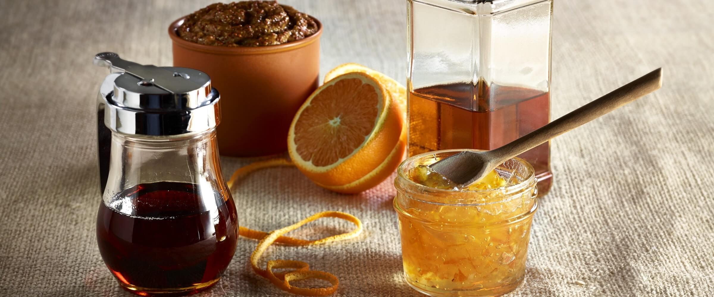 orange bourbon glaze in clear bowl with its ingredients displayed