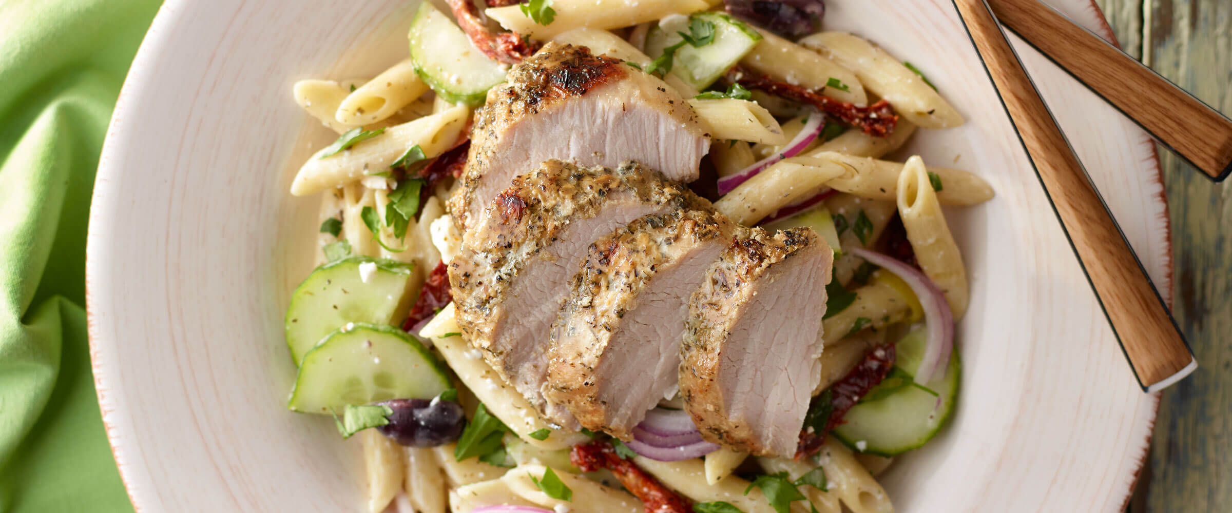 Pork Loin over greek pasta on cream plate