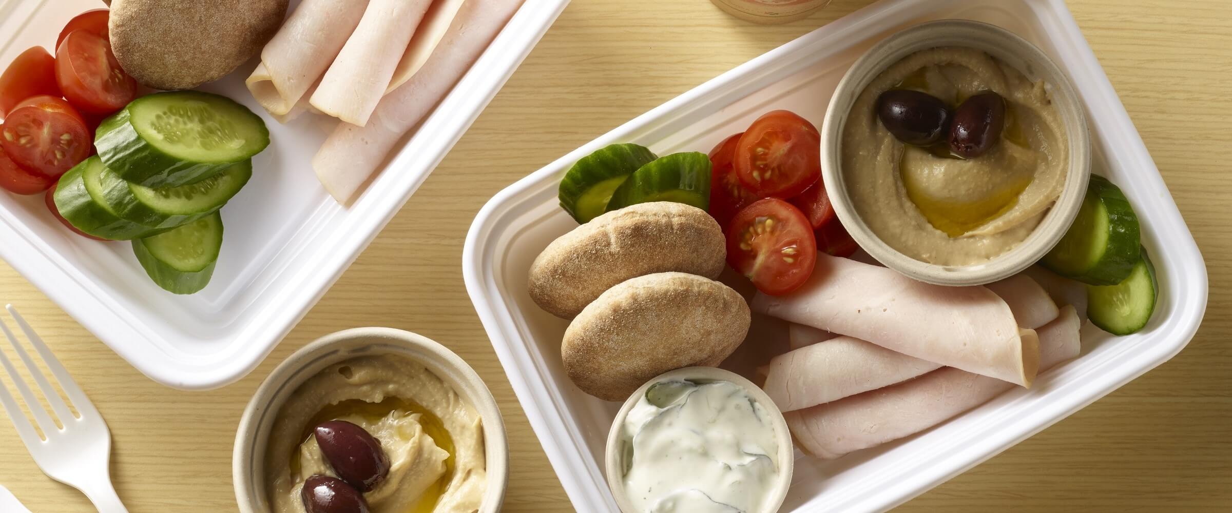 turkey med bento box with hummus, tomatoes, cucumbers, pita bread and dip