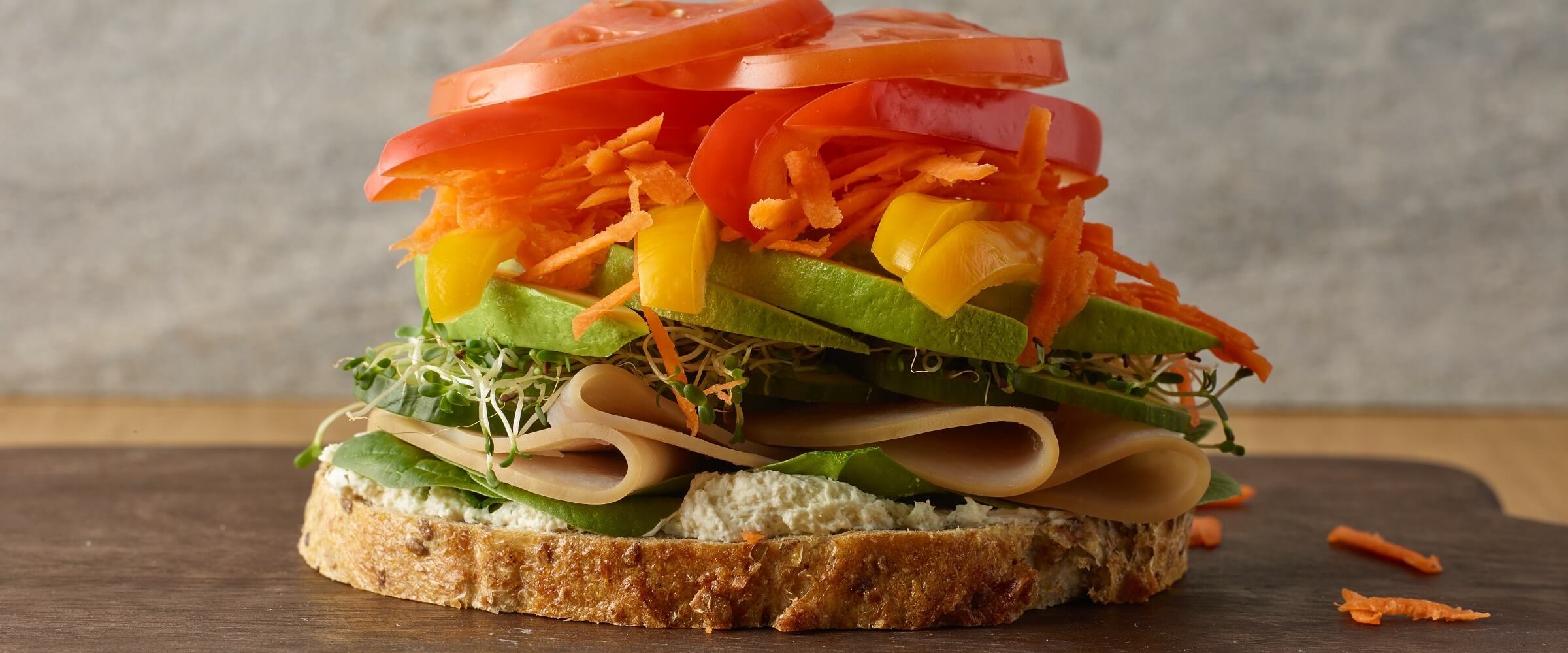 open faced turkey rainbow veggie sandwich piled high with vegetables