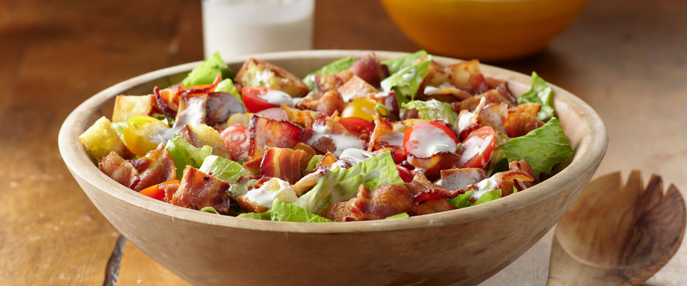 BLT Salad in wooden bowl with serving spoon