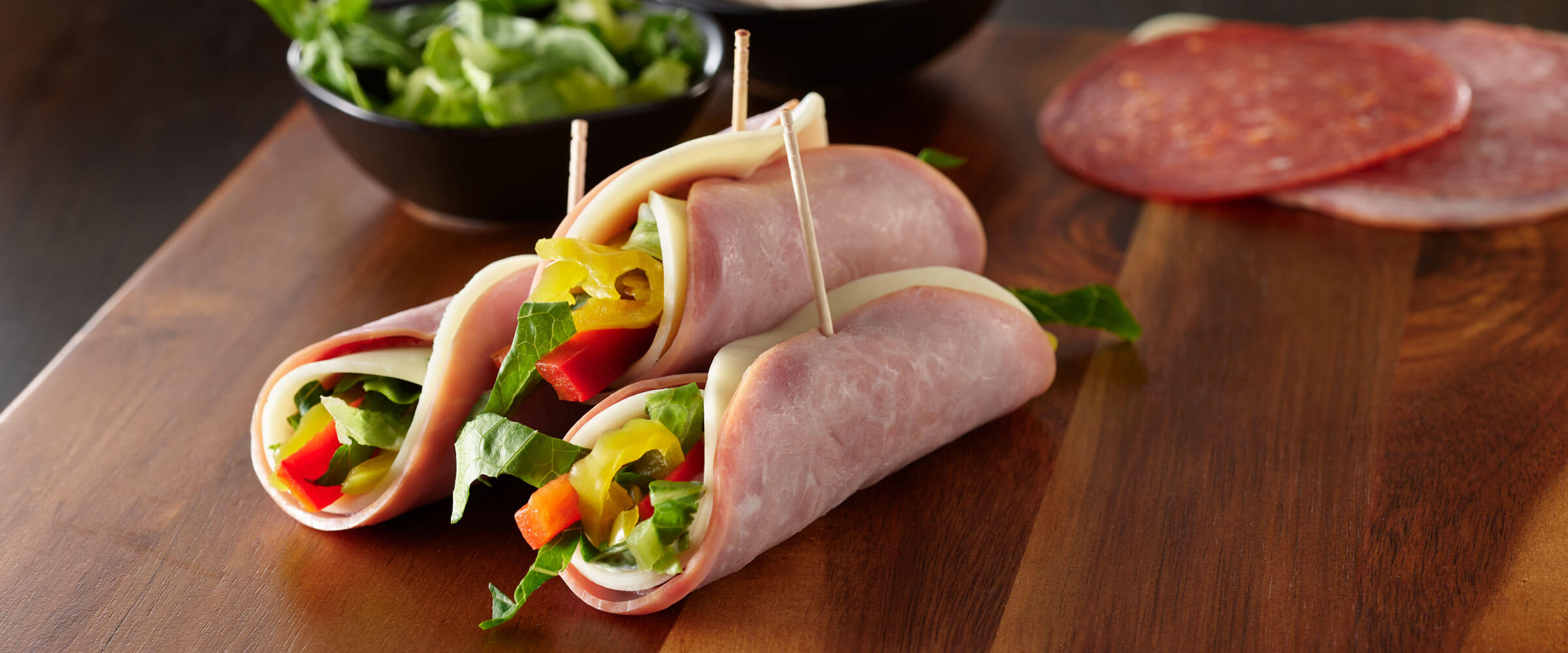Italian Rolled Sandwiches with vegetables and toothpick on wood board