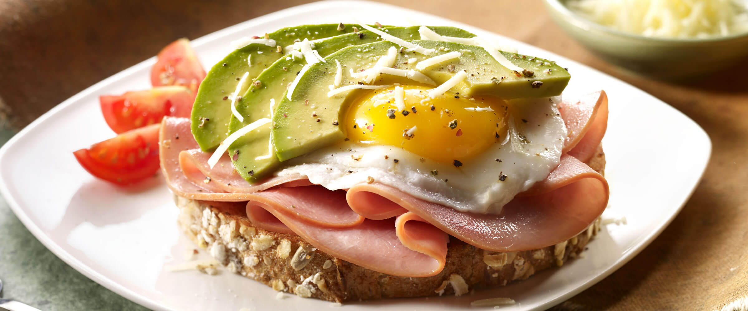 Ham, Egg and Avocado Toasts on white plate