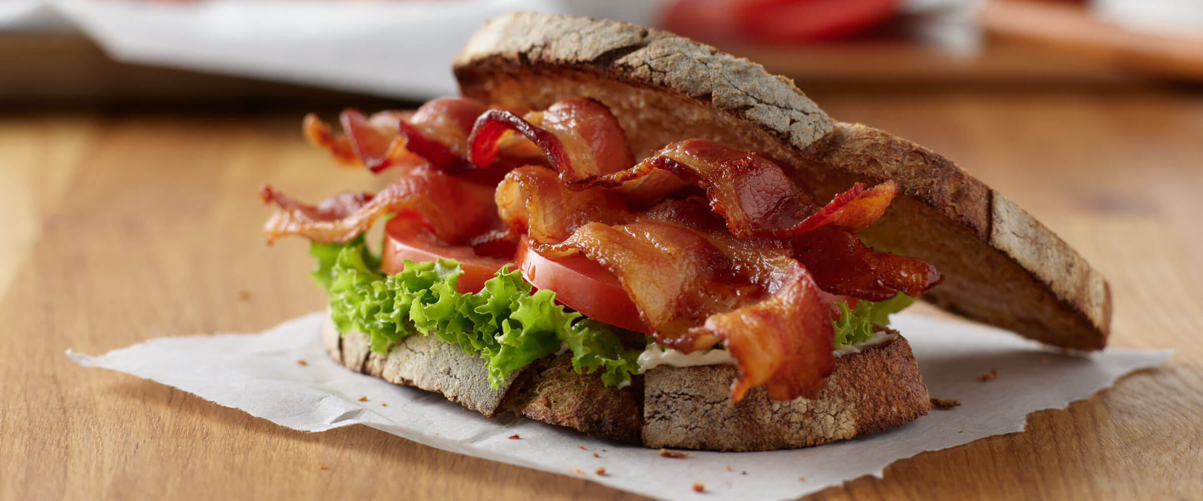 BLT on crusty bread on wooden table