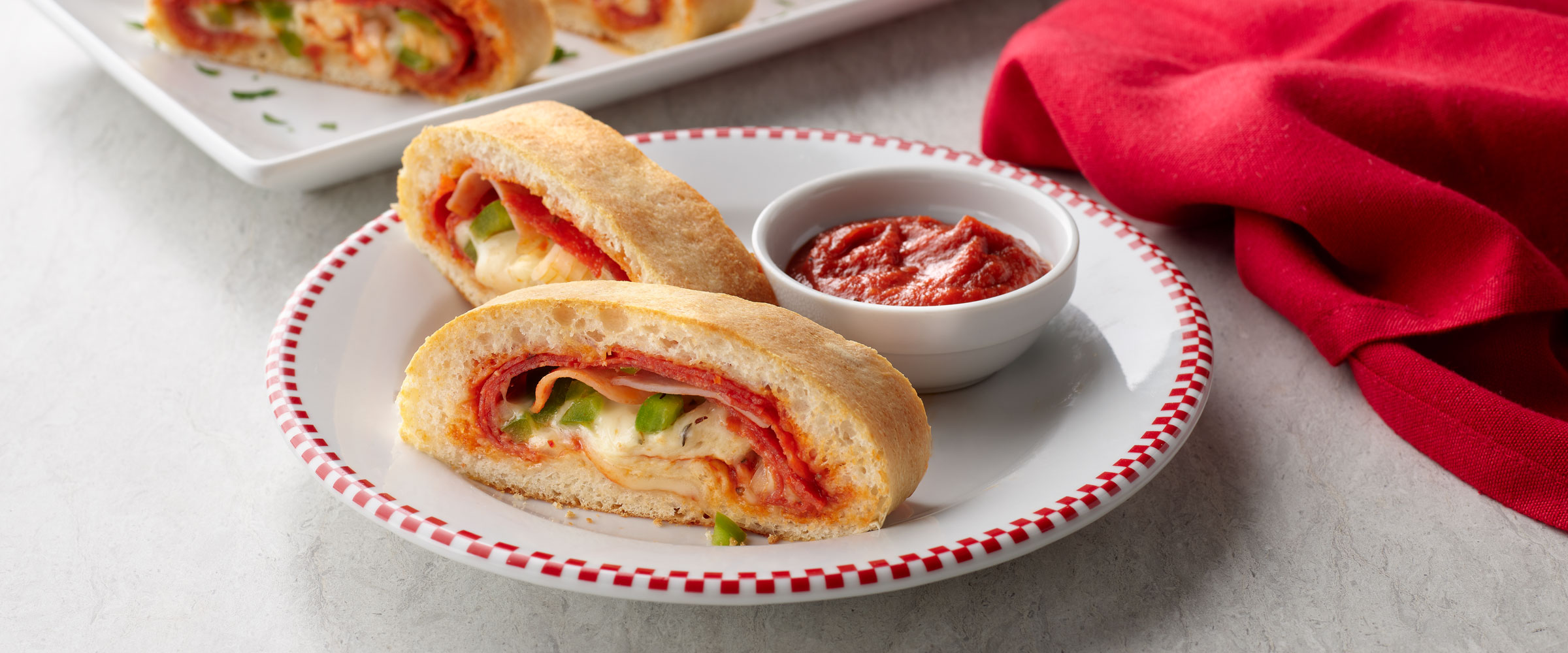 Easy Stromboli slices on plate with dipping sauce