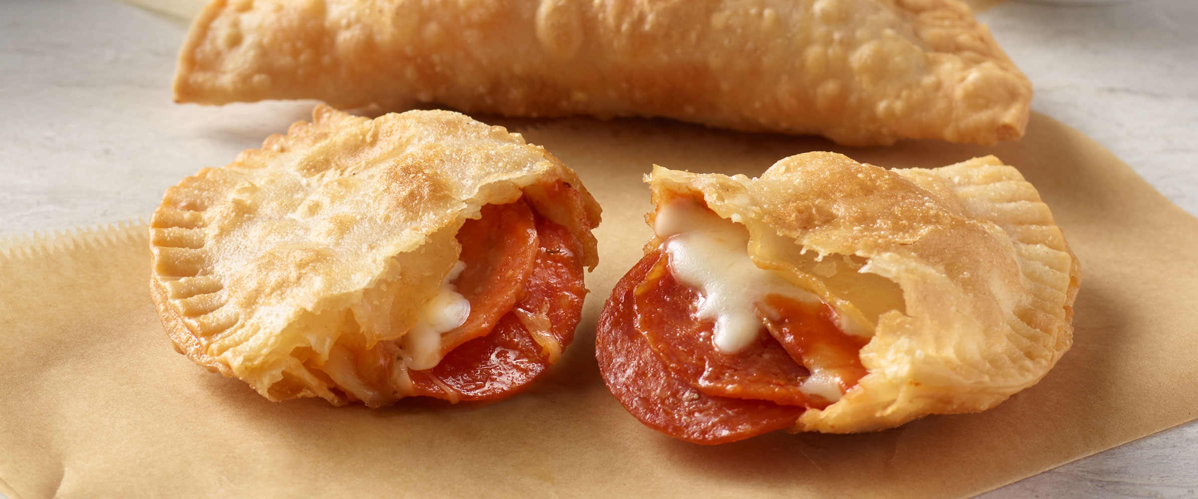 Pepperoni Empanada on brown napkin
