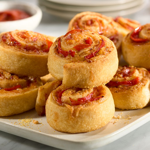 rolls stuffed with pepperoni and cheese on a white plate