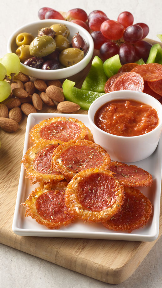 Close up of a snack board featuring pepperoni crisps