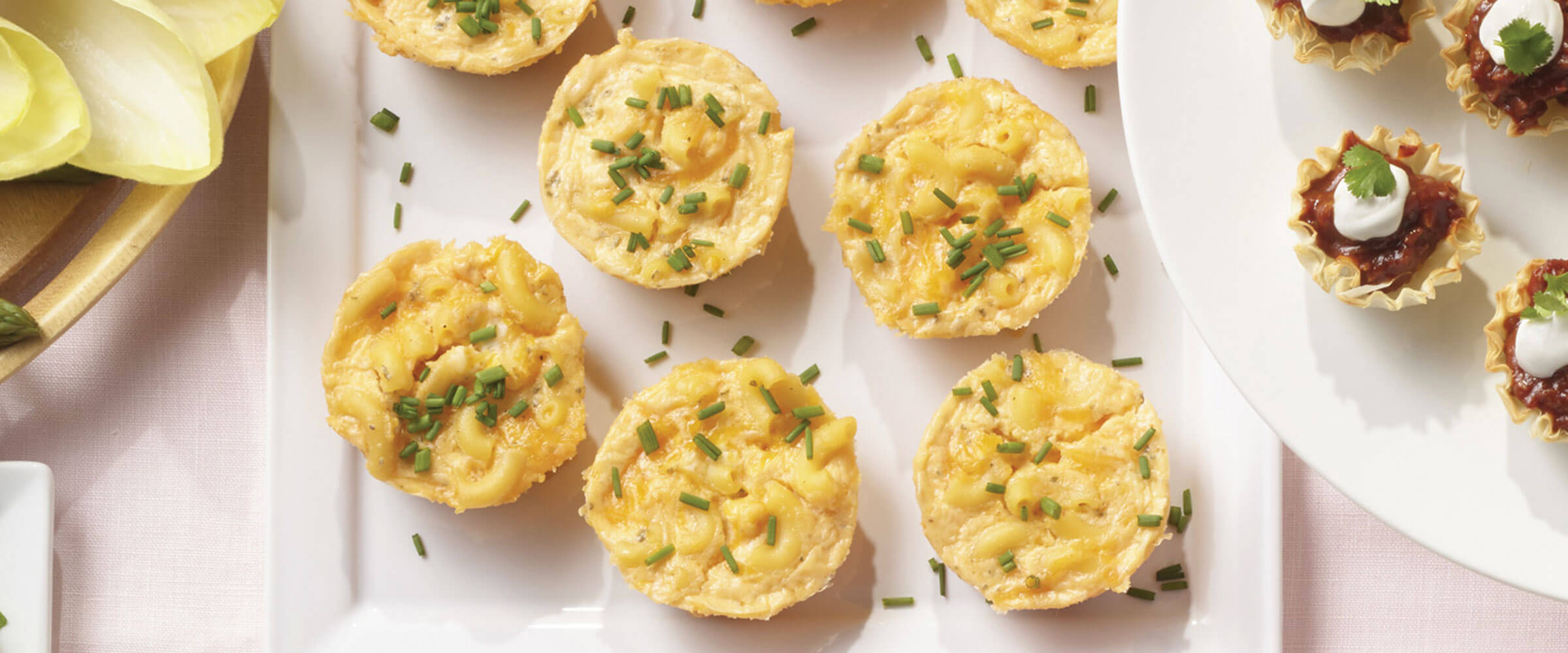 Macaroni and Cheese Cups topped with chives on white platter