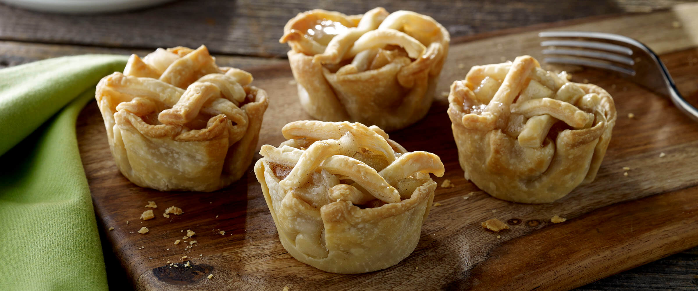 Mini Apple Cinnamon Pies on wood board