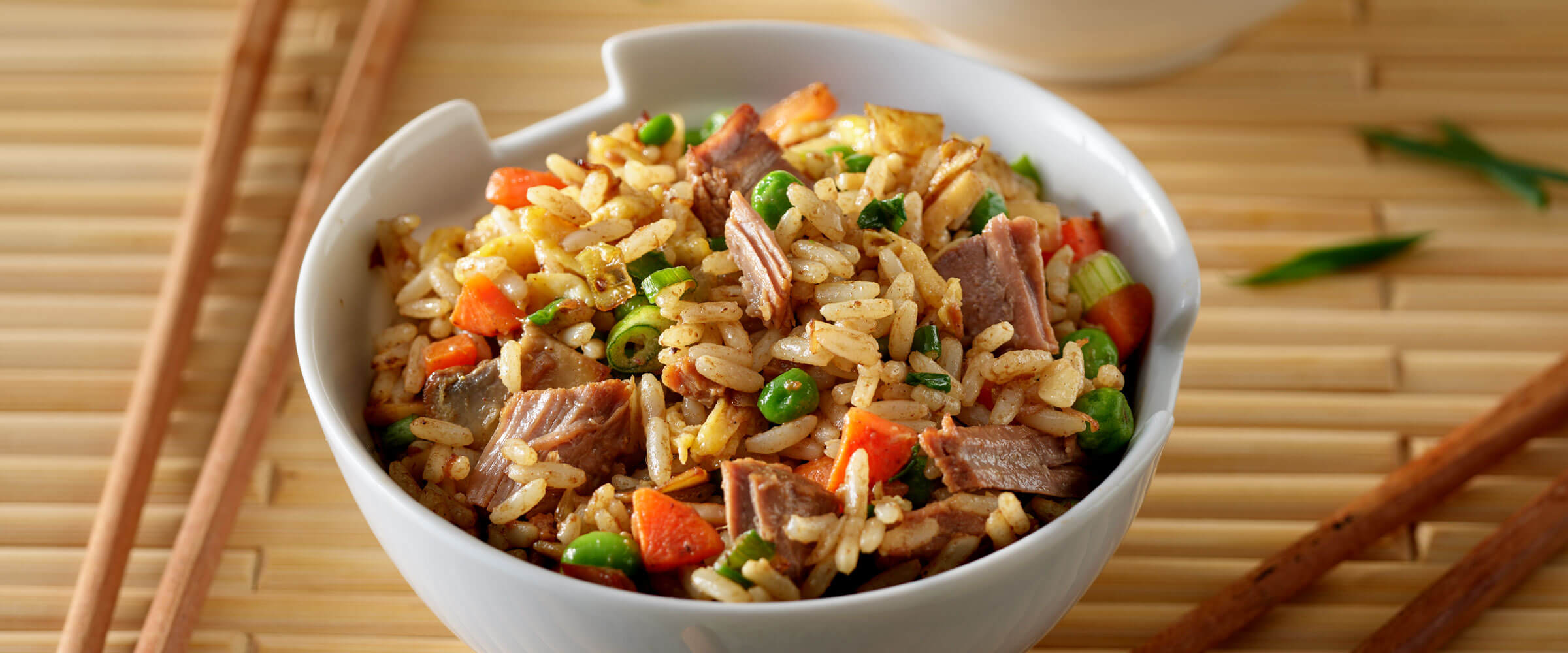 Beef Tips Fried Rice in white bowl with chopsticks