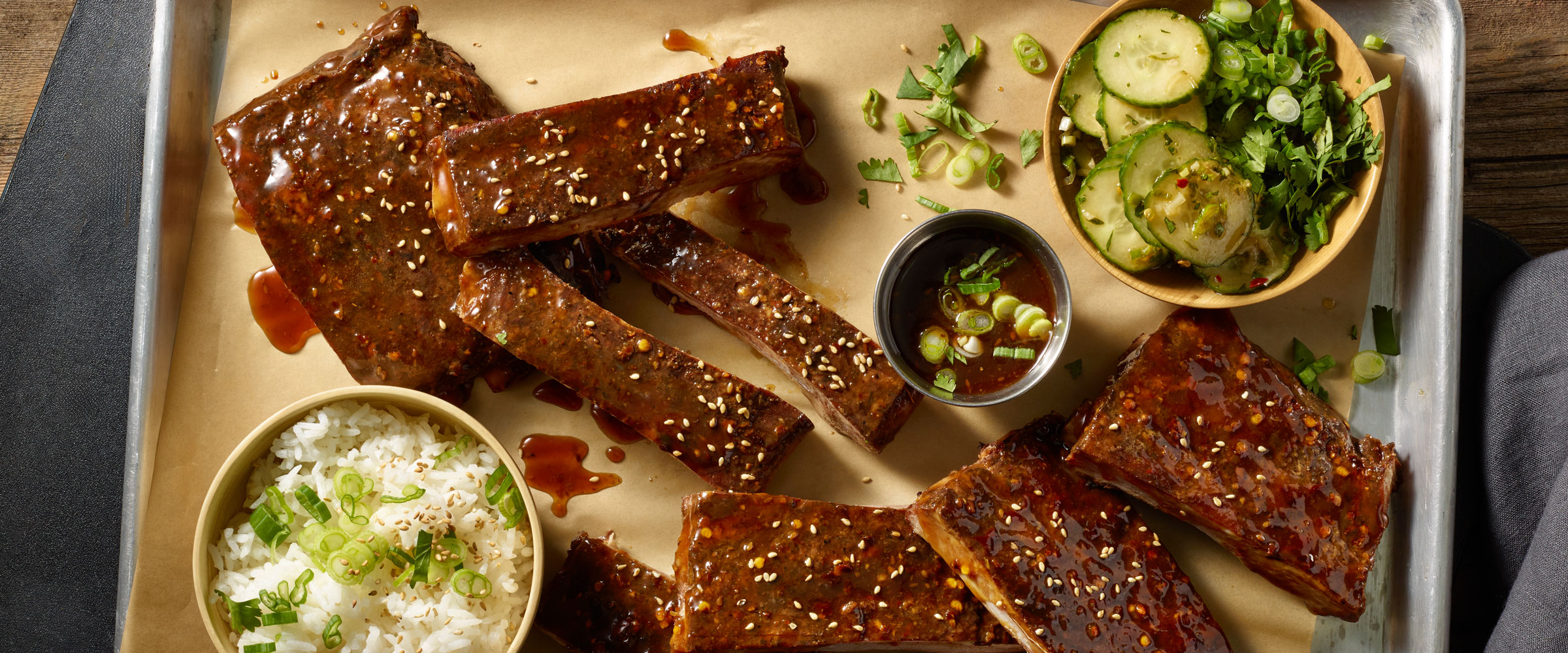 Korean BBQ ribs with rice, pickled cucumbers and extra bbq sauce