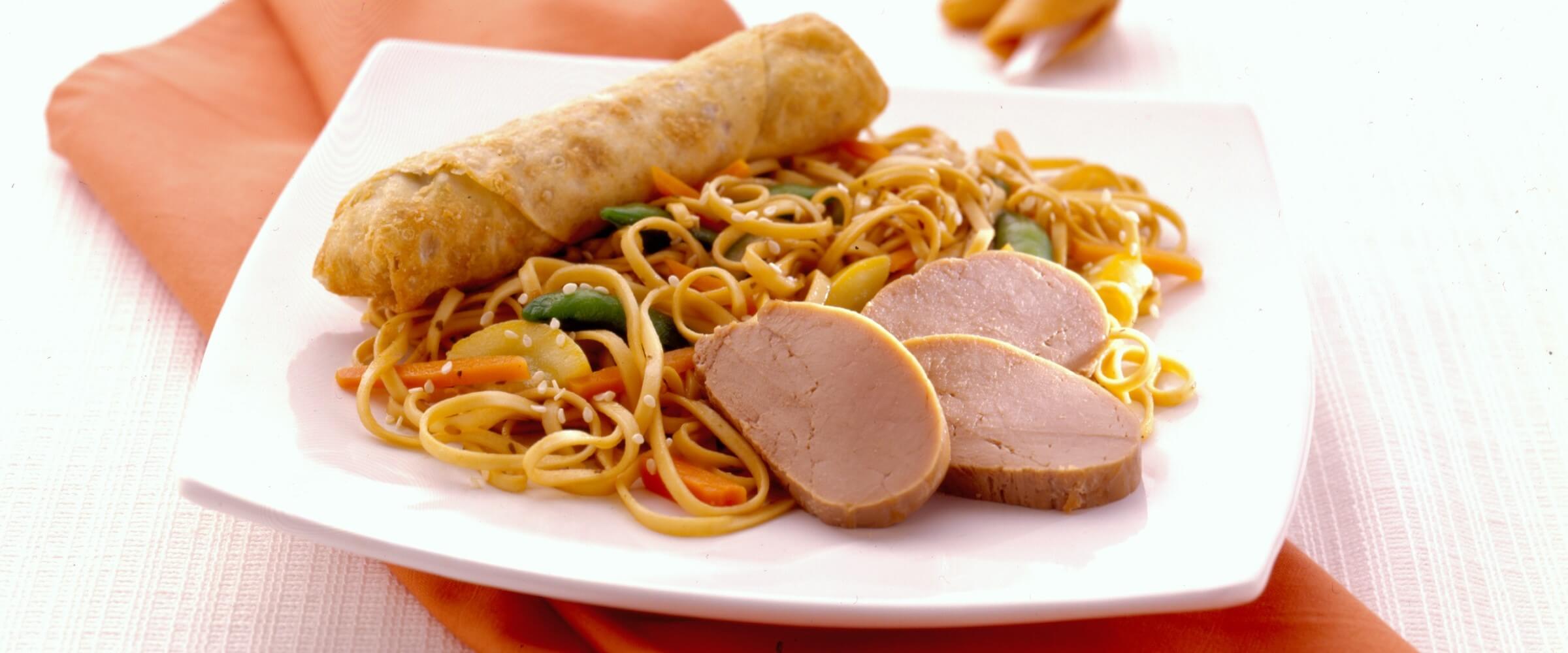 easy pork lo mein over noodles on white plate with orange napkin
