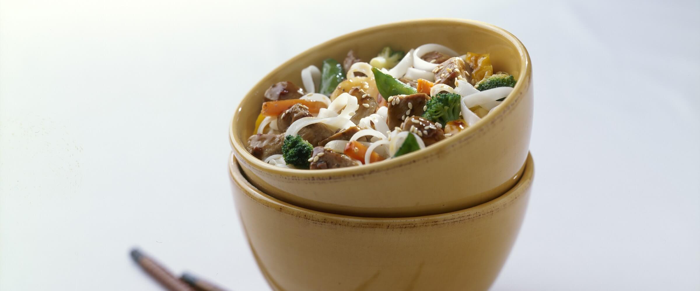 japanese pork stir fry in yellow stacked bowls