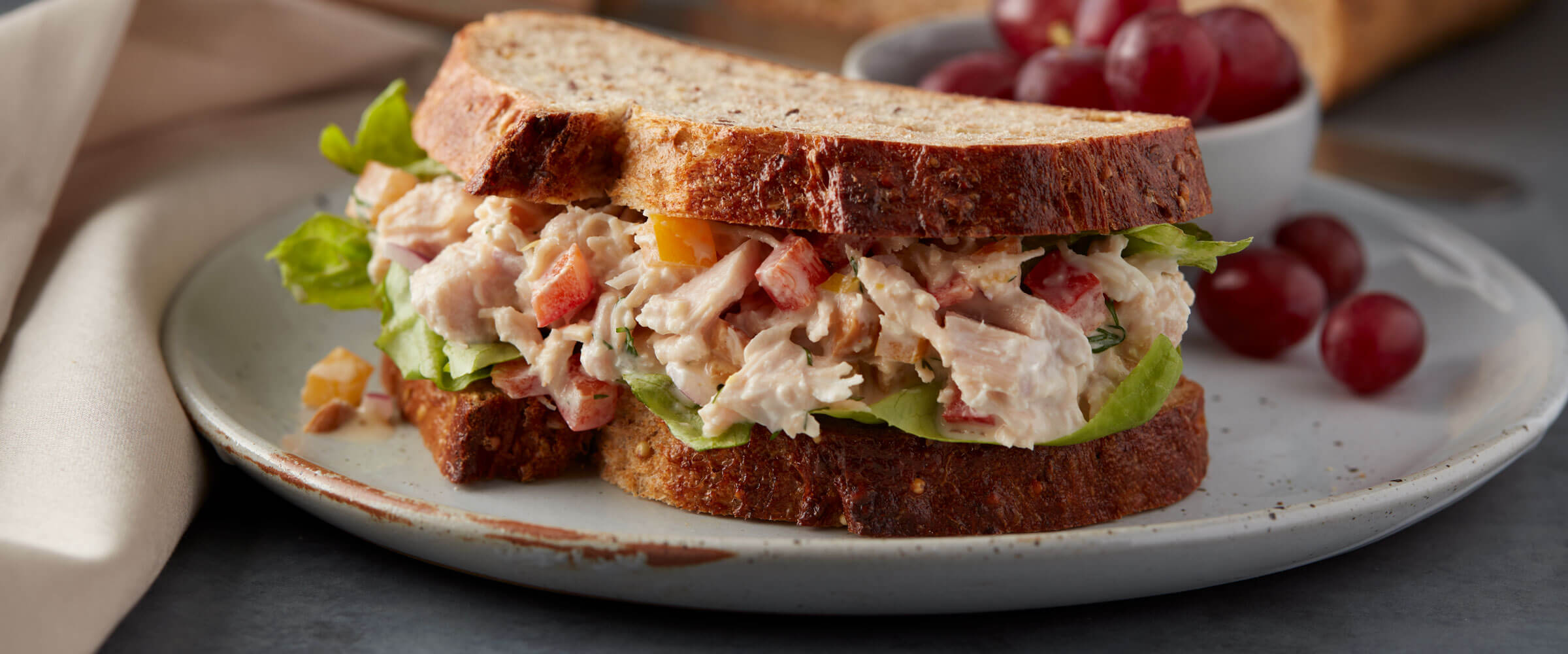 Chicken Salad Sandwich on wheat bread with side of grapes