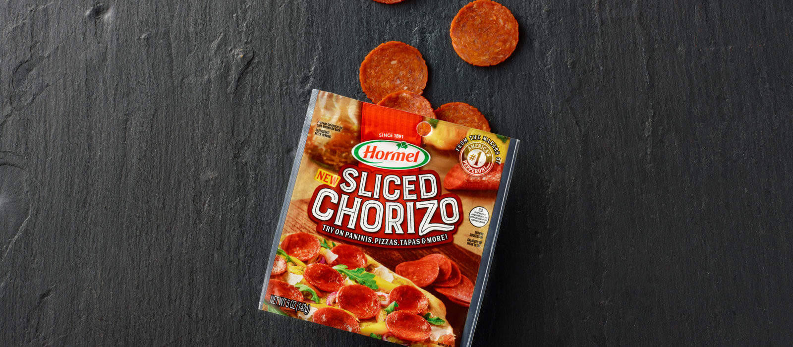 Sliced Chorizo package with slices on black background