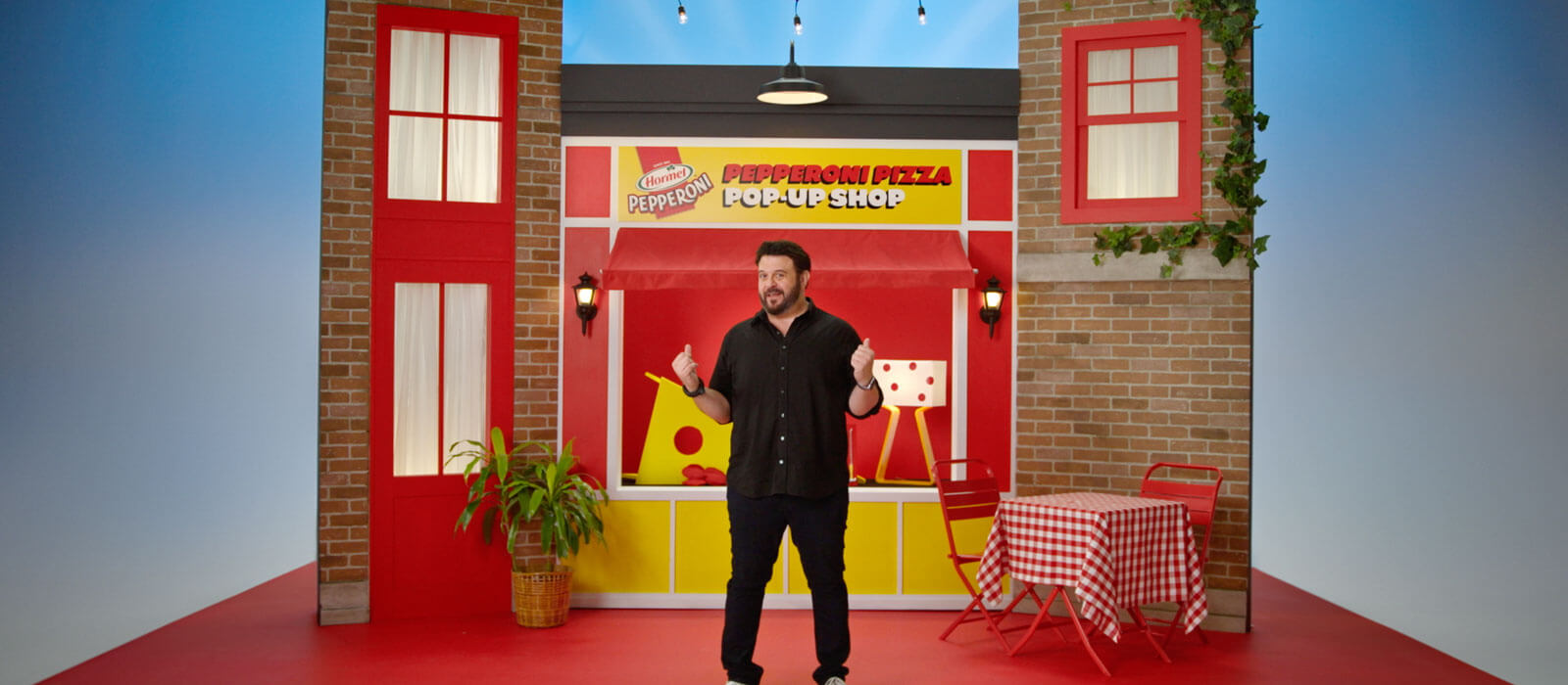 PepperoniShop background with Adam Richmond standing in front