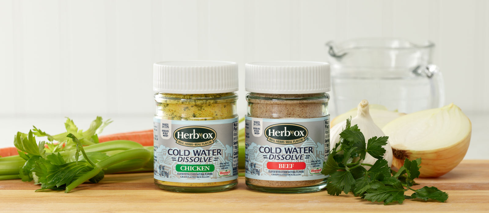 Herb-Ox Cold Dissolve jars on wood board with veggies