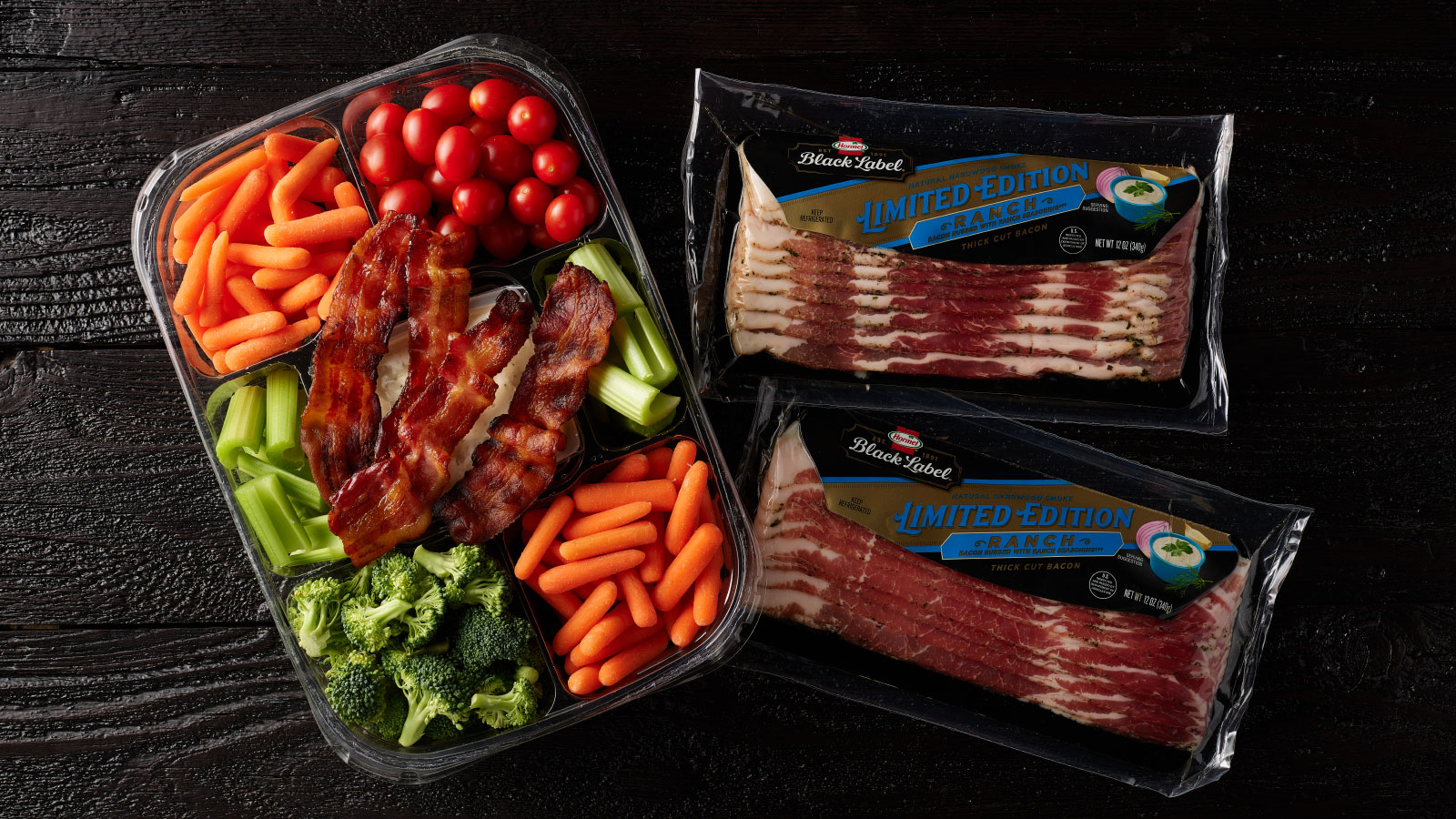 Packages of ranch bacon next to a veggie tray